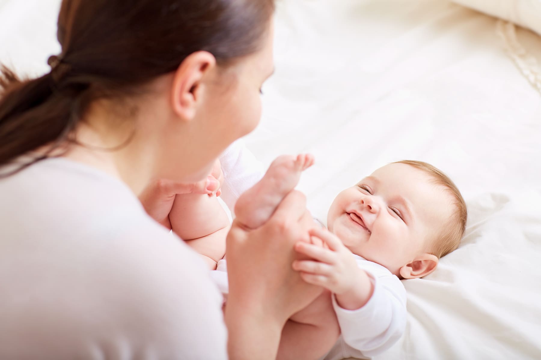 A mother smiling with her baby after a lactation consult